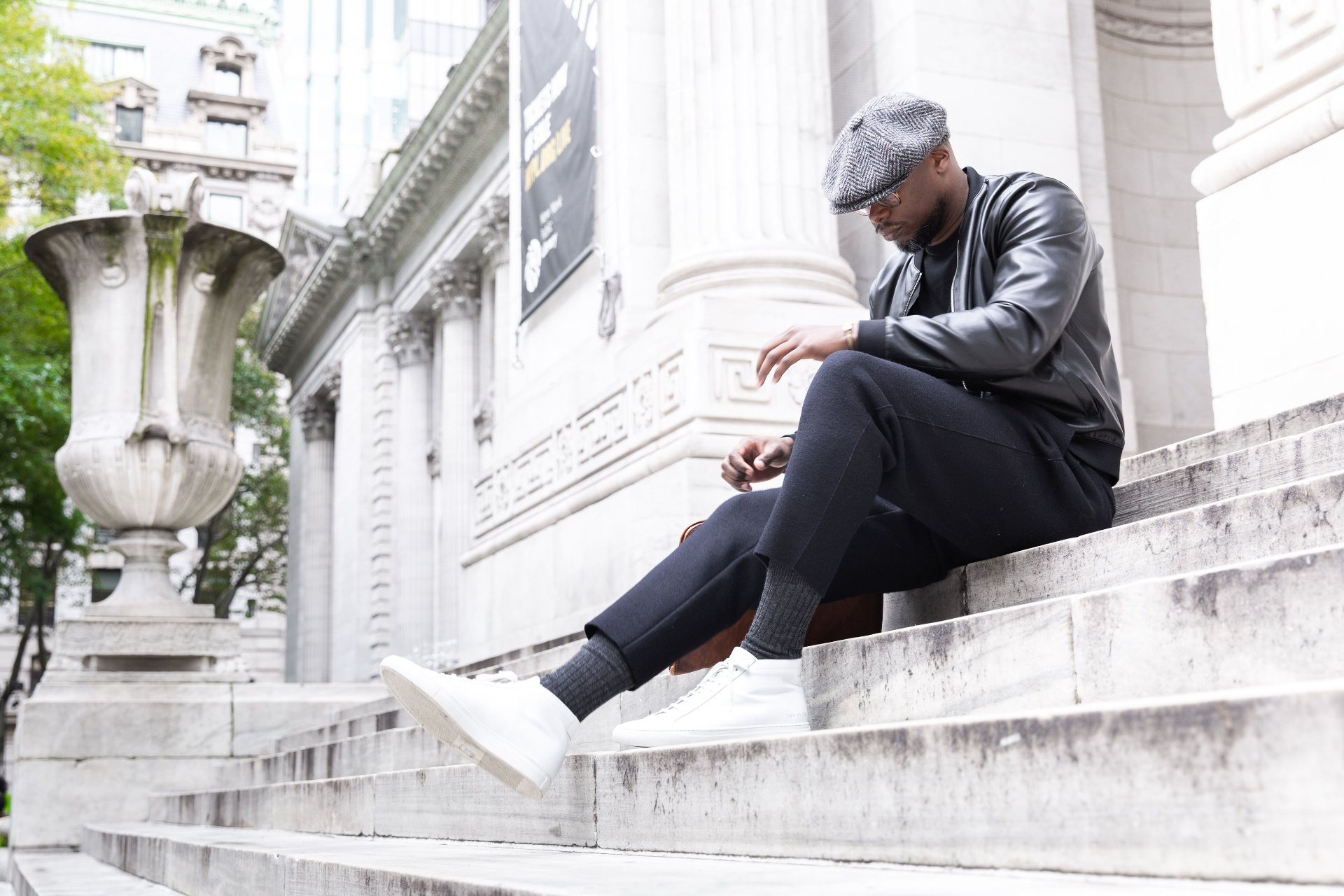 Jason Rosario seated on marble steps in New York