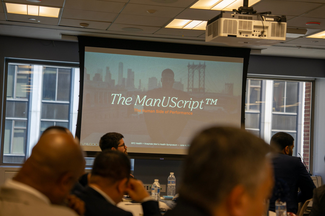 The ManUScript opening slide projected at a men's health symposium
